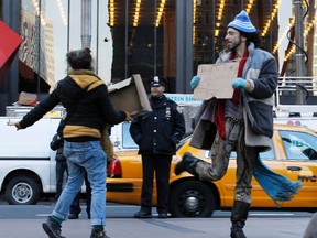 Occupy Wall Street demonstrators protest at Zuccotti Park in New York, January 11, 2012.  Dozens of Occupy Wall Street demonstrators assembled in a New York park on Wednesday, cheered by the overnight removal of barriers that restricted their access for nearly two months to the movement's birthplace. REUTERS/Brendan McDermid