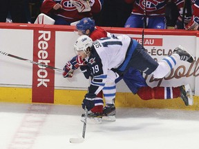 Montreal’s Erik Cole and Winnipeg’s Jim Slater (19) fall as they battle for the puck during the third period of their Wednesday tilt. (JEAN-YVES AHERN/US Presswire)