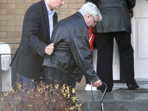 Howie Triano arrives at his Niagara Falls home Friday, Nov. 25, 2011, after being released on bail. Triano's wife Muriel and their son Jay, a former Toronto Raptors coach, help him from a vehicle in their driveway. (MIKE DIBATTISTA /QM AGENCY)