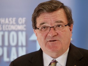 Finance Minister Jim Flaherty speaks with media in Calgary on January 11, 2012. (LYLE ASPINALL/QMI Agency)