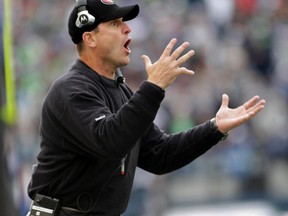San Francisco 49ers head coach Jim Harbaugh yells at officials from the sidelines during the second quarter of their NFL football game against the Seattle Seahawks in Seattle, Washington, December 24, 2011. (REUTERS/Robert Sorbo)