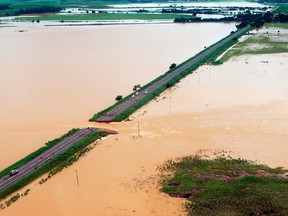 An aerial photograph shows a break in highway BR 356 that was washed away after several days of heavy rains swelled the Muriae River in Campos, 230 km (142 miles) northeast of Rio de Janeiro, January 5, 2012. (REUTERS/Campos Mayor's Office/Handout)