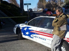 An ATF agent leans against a police car at the scene of a shootout between a narcotics enforcement team and a single gunman in Ogden, Utah January 5, 2012. One police officer was killed and five others were wounded. (REUTERS/James Nelson)