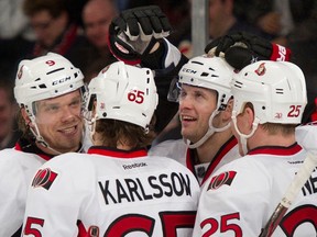 Ottawa Senators left wing Milan Michalek (9), defenseman Eric Karlsson, and right wing Chris Neil (25) congratulate center Jason Spezza after he scored his second goal against the New York Rangers in the third period of their NHL hockey game at Madison Square Garden in New York, January 12, 2012. REUTERS/Ray Stubblebine (UNITED STATES - Tags: SPORT ICE HOCKEY)
