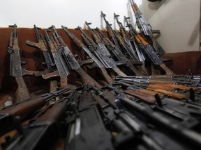 AK-47 weapons seized from two men along with their driver and interpreter are presented to the media in Kabul January 5, 2012. (REUTERS/Omar Sobhani)