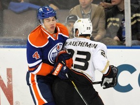 Taylor Hall collides with Francois Beauchemin during tFriday night's 5-0 Anaheim win at Rexall Place.
Reuters