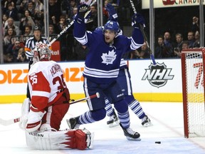 Clarke MacArthur celebrates behind Jimmy Howard after Dion Phaneuf's point shot beat the Wings netminder in the first period on Saturday night at the ACC. The Leafs blew a 3-0 lead before winning it 4-3. (Mike Peake, Toronto Sun