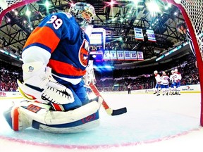 Islanders goalie Rick DiPietro lets in a goal by Erik Cole of Montreal. (AFP)
