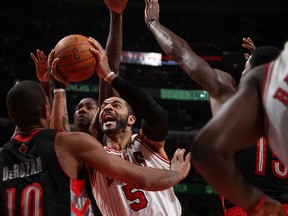 Bulls forward Carlos Boozer tries to shoot against the Toronto Raptors during Saturday night's game in Chicago. (AFP)