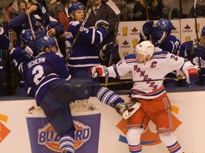 New York Rangers captain Ryan Callahan checks Leafs’ Luke Schenn hard along the boards at the Air Canada Centre on Saturday night. (Jack Boland, Toronto Sun)