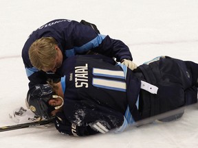 A Pittsburgh Penguins trainer tends to Jordan Staal who was injured when he was kneed by New York Rangers Mike Rupp in the third period of their NHL hockey game in Pittsburgh, Pennsylvania January 6, 2012. REUTERS/Jason Cohn