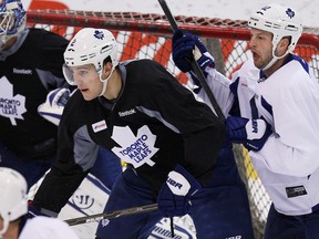 Maple Leafs defenceman Luke Schenn (left) boxes out forward Tim Connolly during practice on Monday. (Craig Robertson/Toronto Sun)