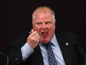 Mayor Rob Ford chowing down on some grapefruit during a council meeting last September. (Michael Peake/Toronto Sun files)