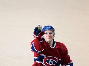 Canadiens forward Lars Eller throws a puck to the crowd after facing the Jets at the Bell Centre in Montreal, Que., Jan. 4, 2012. (CHRISTINNE MUSCHI/Reuters)