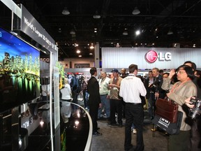 Showgoers look at a display of 55-inch 3D OLED televisions at the LG Electronics booth during the 2012 International Consumer Electronics Show (CES) in Las Vegas, Nevada Jan. 10, 2012. REUTERS/Steve Marcus
