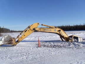 A John Deere Model 892 E LC excavator operated by the Manto Sipi Cree Nation (God's River Manitoba) that has gone through the ice where a winter road should be. The community has no functioning winter road as temperatures haven't been low enough over the winter of 2011-12. (HANDOUT)