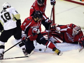 Capitals forward Alexander Ovechkin (centre) and goaltender Tomas Vokoun try to keep the puck out of the crease as Penguins forward James Neal closes in at the Verizon Center in Washington, D.C., Jan. 11, 2012. (KEVIN LAMARQUE/Reuters)