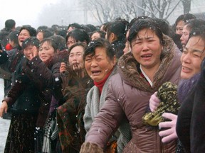 Crowds react as they attend the funeral procession for late North Korean leader Kim Jong-il in Pyongyang, in this photo taken by Kyodo on December 28, 2011. (REUTERS/Kyodo)