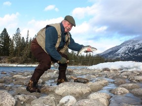 Neil with a winter bull trout caught from the Athabasca
River in Jasper National Park.