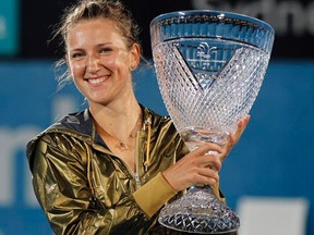 Victoria Azarenka holds the trophy after defeating Li Na during their women's final at the Sydney International on Friday, Jan. 13, 2012. (REUTERS/Daniel Munoz)