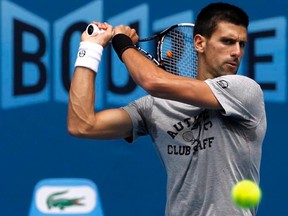 Novak Djokovic hits a ball during practice before the Australian Open in Melbourne on Friday, Jan. 13, 2012. (REUTERS/Mark Blinch)