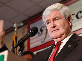 Republican presidential candidate and former Speaker of the House Newt Gingrich holds up three fingers as he refers to a newspaper fact checking column which gave his opponent Mitt Romney three 'Pinocchios', as he speaks at a rally at the Versailles restaurant in the Little Havana neighborhood in Miami, January 13, 2012.    REUTERS/Joe Skipper