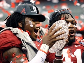 Alabama Crimson Tide defensive back Dre Kirkpatrick holds the BCS trophy after Alabama defeated the LSU Tigers during the NCAA BCS National Championship college football game in New Orleans January 9, 2012. (REUTERS/Jeff Haynes)