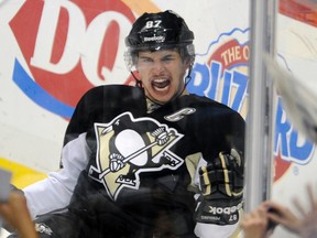 Pittsburgh Penguins Sidney Crosby (87) celebrates his first goal of the season against the New York Islanders in the first period of their NHL hockey game in Pittsburgh, Pennsylvania, November 21, 2011. (REUTERS/David DeNoma)