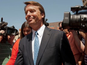 Former U.S. Democratic presidential hopeful and former U.S. Senator John Edwards departs the U.S. District Court with his daughter Cate (L-rear) after pleading not guilty to six federal charges in Winston-Salem, North Carolina, June 3, 2011. (REUTERS/Davis Turner)