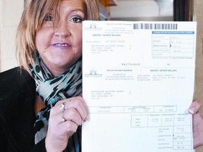 Cara Zandvliet holds up her late father's water bill for close to $600. Zandvliet claims her father was unfairly charged by the City of Port Colborne for three weeks of water usage. QMI Agency
