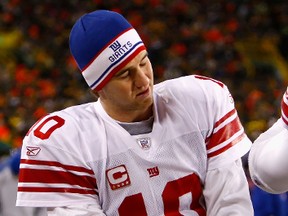 Giants quarterback Eli Manning tries to keep warm during The Freezer Bowl — the 2008 NFC title game at Lambeau Field — which New York won and later the Super Bowl. (Jamie Squire, Getty Images)