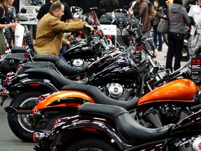 A man sits on a new motorcycle in the Kawasaki booth at the Edmonton Motorcycle Show. (TOM BRAID/EDMONTON SUN FILE PHOTO)