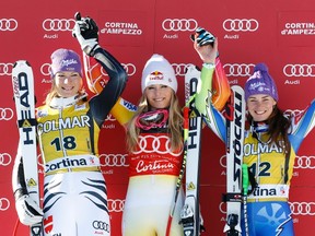 Lindsey Vonn of the U.S. (C) celebrates on the podium with second placed Maria Hoefl-Riesch of Germany (L) and third placed Tina Maze of Slovenia after winning the ladies' super G Alpine Skiing World Cup event in Cortina D'Ampezzo January 15, 2012.  REUTERS/Tony Gentile