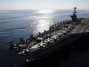 The aircraft carrier USS John C. Stennis transits the Straits of Hormuz in this U.S. Navy handout photo dated November 12, 2011.