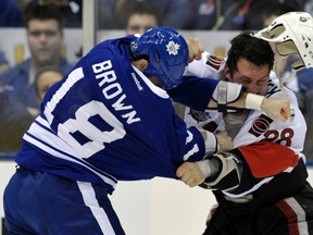 Toronto Maple Leafs forward Mike Brown fights Ottawa Senators forward Zenon Konopka earlier this season. (REUTERS)