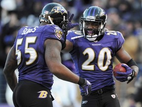Baltimore Ravens free safety Ed Reed (right) celebrates his fourth quarter interception against the Houston Texans with teammate Terrell Suggs during their AFC Divisional playoff game on Sunday. (Reuters)