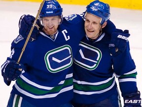 Sami Salo (right), seen here celebrating his goal with teammate Henrik Sedin last October, has been out of the Canucks lineup with a concussion. (REUTERS/Ben Nelms/Files)