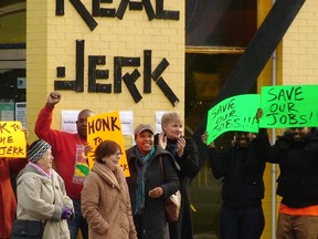 Employees and supporters protest at the Real Jerk Restaurant. (KEVIN CONNOR, Toronto Sun)