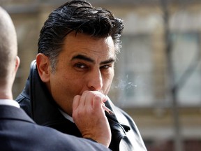 Accused drug squad officer Ned Maodus has a cigarette during lunch break. (CRAIG ROBERTSON, Toronto Sun)