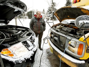 Zib Szatkowski works on trying to jump start a small bus in Edmonton on a very cold Monday January, 16, 2012. Inspite of having the vehicle plugged in the engine would not turn over in the frigid weather.  TOM BRAID/EDMONTON SUN  QMI AGENCY