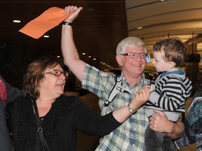 Andrea (L) and Laurence Davis (R) are re-united with their grandson Caleb Hornstein 3 yrs-old as their family meets them at the Calgary International Airport on January 16th, 2012 where they arrived from London, England via Italy where they were one of the lucky survivors who has swam to shore from a sinking cruise ship the Costa Concordia, when it hit rocks near the port area of Giglio and capsized late Friday. (STUART DRYDEN/QMI AGENCY)