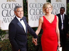 Actor and director George Clooney arrives with girlfriend Stacy Keibler on the red carpet at the 69th annual Golden Globe Awards in Beverly Hills, California January 15, 2012.  REUTERS/Mario Anzuoni