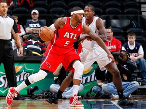 Hawks forward Josh Smith drives past Raptors' Ed Davis during Monday's game in Atlanta. (AFP)