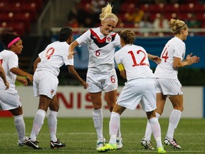 Canada's Kaylyn Kyle (centre) celebrates her goal against Colombia with teammate Christine Sinclair during the women's soccer semifinal at the Pan American Games in Guadalajara, Mexico, Oct. 25, 2011. (ALEJANDRO ACOSTA/Reuters)