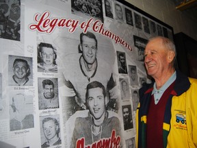 Former Rockets captain John young poses next to a poster of the team from the ’60s. (Lisa Joy, QMI Agency)