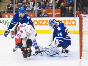 Maple Leafs’ Luke Schenn checks the Senators’ Kaspars Daugavins in front of goalie James Reimer at the ACC last night. Former Islanders great Denis Potvin believes that goalies get too worn down during the regular season and then end up underperforming in the playoffs. (Ernest Doroszuk/Toronto Sun)