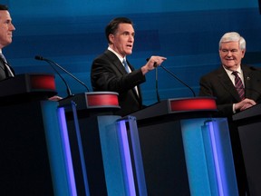 Republican presidential candidates former U.S. Senator Rick Santorum (R-PA) and former House Speaker Newt Gingrich (R) listen as former Massachusetts Governor Mitt Romney (C) speaks as they participate in a Republican presidential candidates debate in Myrtle Beach, South Carolina, January 16, 2012. (REUTERS/Charles Dharapak/POOL)