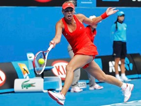 Caroline Wozniacki hits a return to Anna Tatishvili during their women's singles match at the Australian Open in Melbourne on Wednesday, Jan. 18, 2012. (REUTERS/Daniel Munoz)