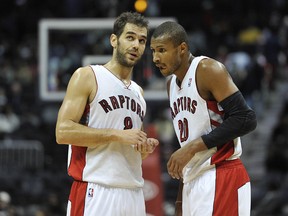 Raptors guard Jose Calderon (left) and Leandro Barbosa talk during a break in play against the Atlanta Hawks on Monday. (US Presswire)