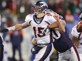 Broncos quarterback Tim Tebow fumbles the ball as he is hit by Patriots linebacker Rob Ninkovich during NFL playoff action in Foxborough, Mass., on Saturday, Jan. 14, 2012. (REUTERS/Brian Snyder)